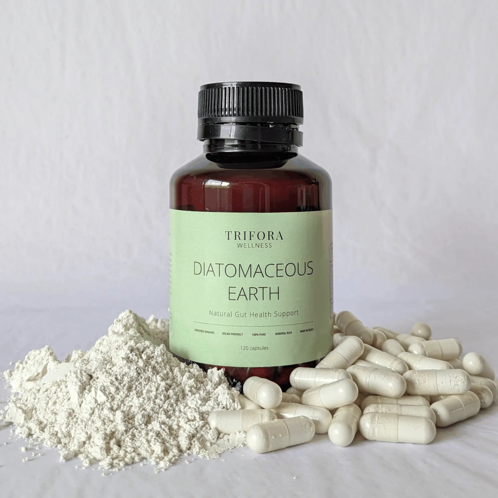 Bottle of Trifora Wellness Diatomaceous Earth supplement with powder and capsules on a light gray background