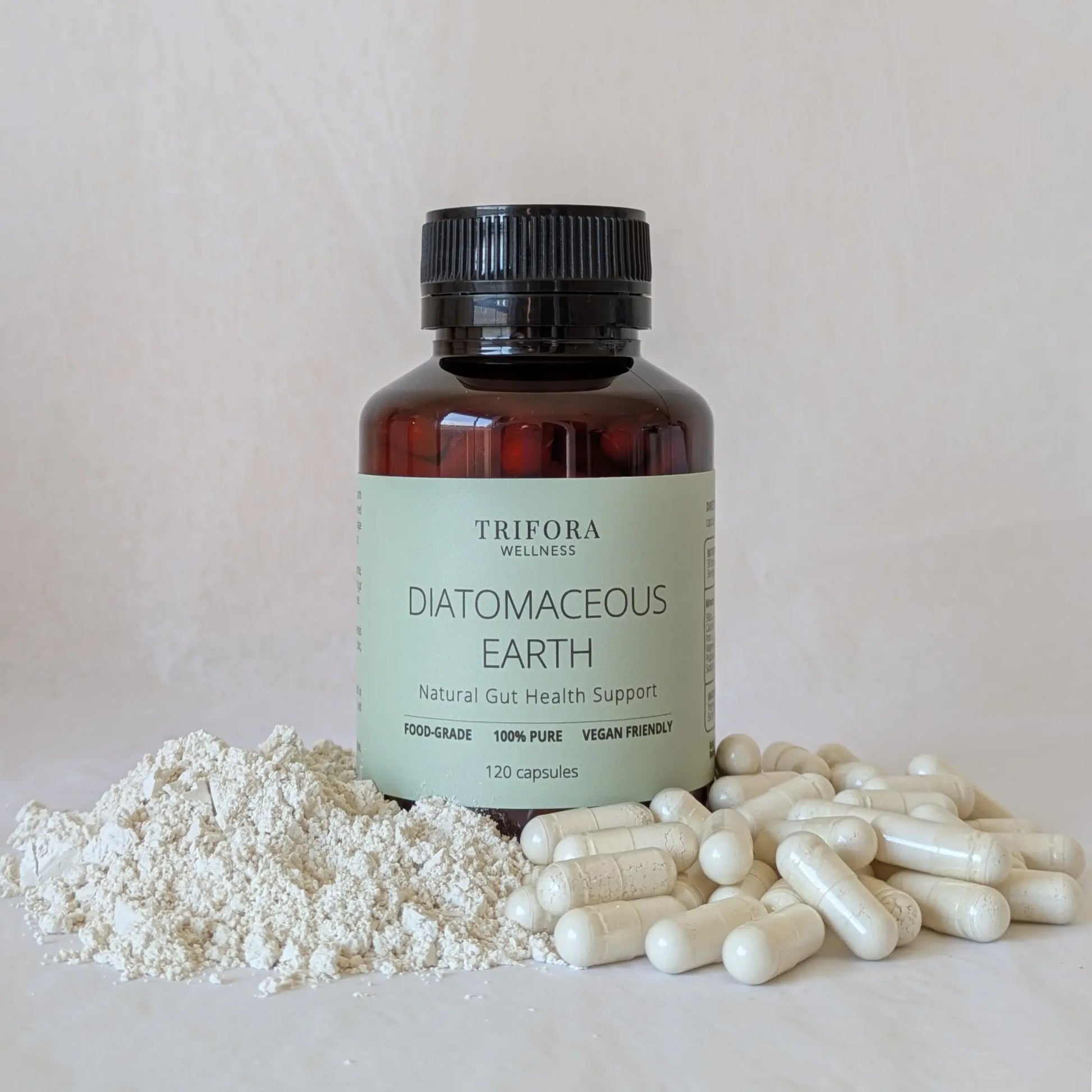 Bottle of Trifora Wellness Diatomaceous Earth with powder and capsules on a light background